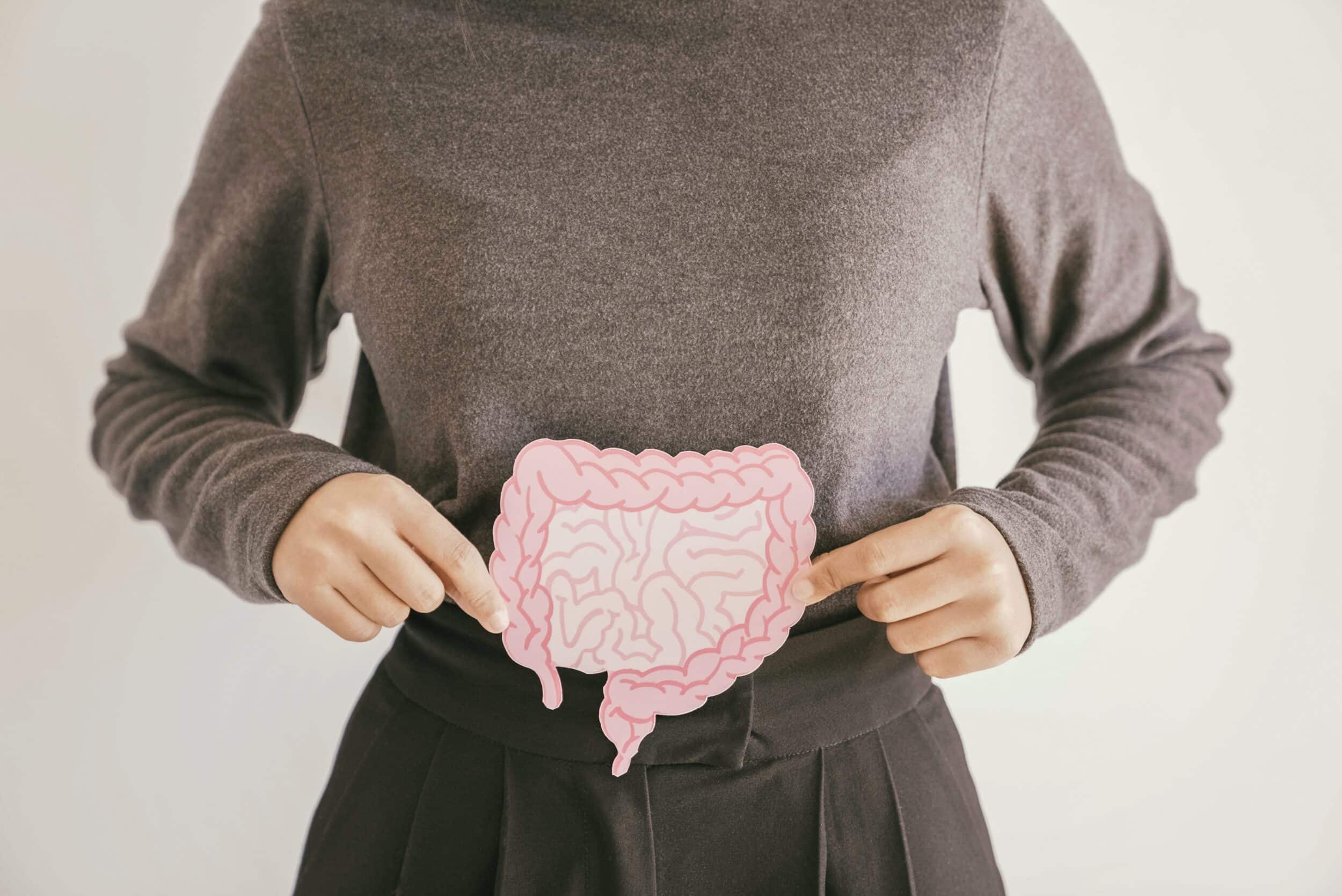 Woman holding a cutout of intenstines to demonstrate gut health